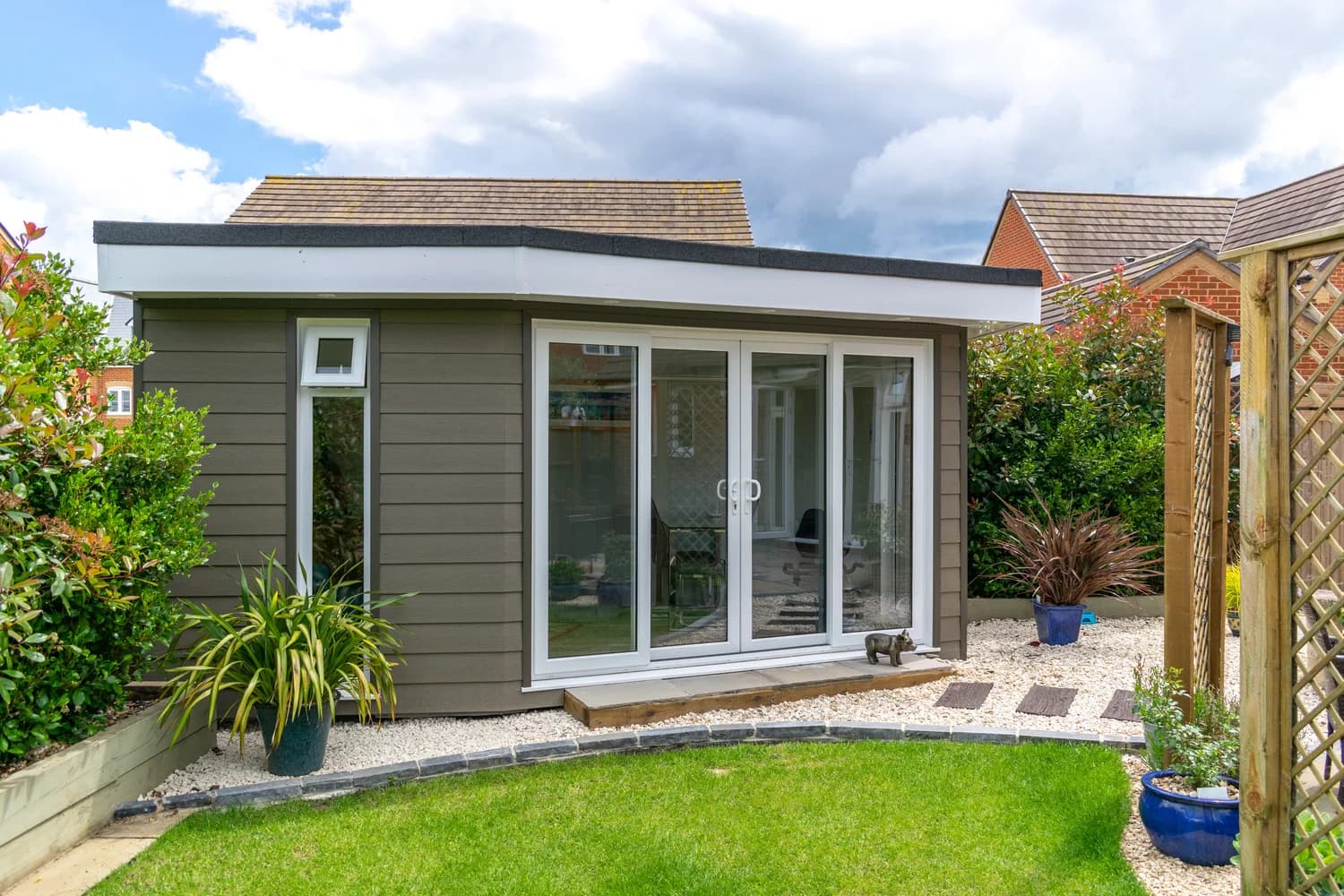 Grey garden building with French doors